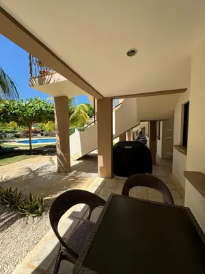 a patio with a table and chairs and a pool at EndlessSummer Beach Escape in Coco