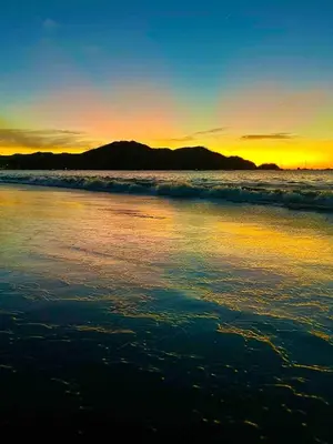 a sunset on the beach with the ocean at EndlessSummer Beach Escape in Coco