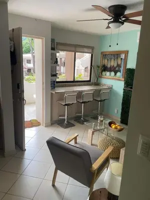 a living room with a bar with a couch and chairs at Discounted - PuraVida Escape and rooftop terrace in Coco
