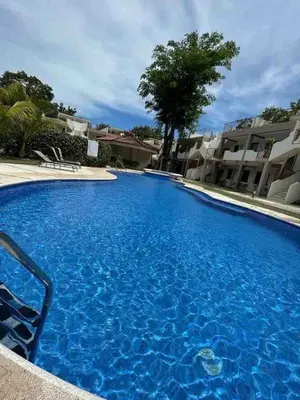 a large blue swimming pool next to some buildings at Discounted - PuraVida Escape and rooftop terrace in Coco