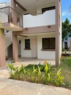 a house with a balcony and some plants at Discounted - Beach Dreams Coco Ground Floor Unit in Coco