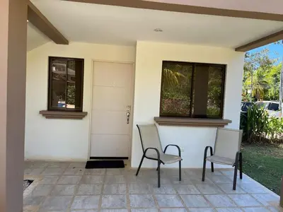 two chairs sitting in front of a house at Discounted - Beach Dreams Coco Ground Floor Unit in Coco