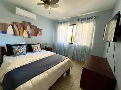 a bedroom with a bed and a ceiling fan at Sea Bottom Ground Condo in Coco