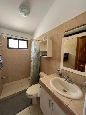 a bathroom with a toilet and a sink at Coral Reef Condo in Coco