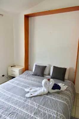 two swans sitting on top of a bed at Coral Reef Condo in Coco