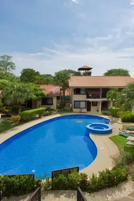 an image of a swimming pool in front of a house at Coral Reef Condo in Coco