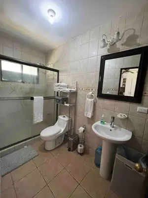 a bathroom with a toilet and a sink at Cabaña en el Sol Cabin in the Sun in Ocotal