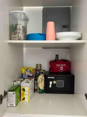 a kitchen shelf with a microwave and some food at Cabaña en el Sol Cabin in the Sun in Ocotal
