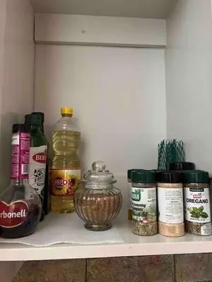 a shelf with spices and a jar of food at Cabaña en el Sol Cabin in the Sun in Ocotal