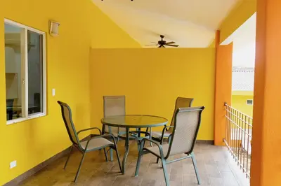 a dining room with yellow walls and a table and chairs at Discounted - Hermosa Paradise Mins from beach in Playa Hermosa
