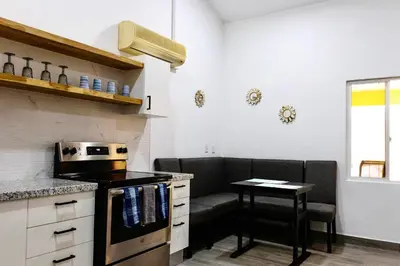 a kitchen with a couch and a table in it at Discounted - Hermosa Paradise Mins from beach in Playa Hermosa