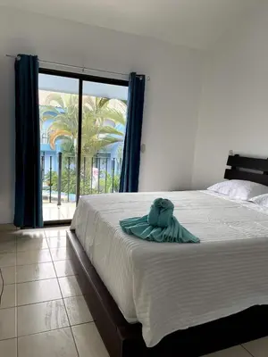 a bed with a towel on it in a bedroom at Charming Condo Orchidea in Coco