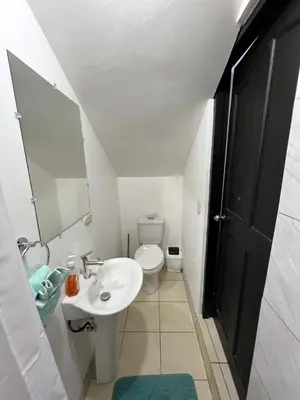 a white bathroom with a sink and a toilet at Charming Condo Orchidea in Coco