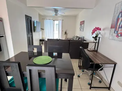 a kitchen and dining room with a table and chairs at Charming Condo Orchidea in Coco