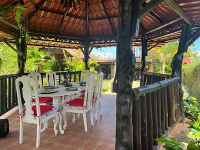 a table and chairs sitting under a gazebo at Pitangus Lodge in Chachagua