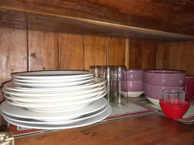 a stack of plates and bowls sitting on a table at Natural Pacific Suites, Manuel Antonio-Quepos-Hotel in Manuel Antonio