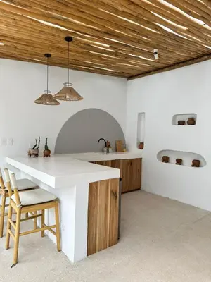 a kitchen with a white counter and a wooden ceiling at Las Guapas Villas Tamarindo in Tamarindo