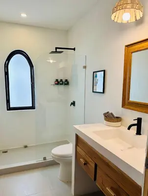 a bathroom with a sink and a toilet and a shower at Las Guapas Villas Tamarindo in Tamarindo