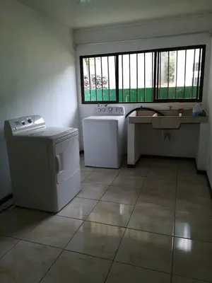 a kitchen with a stove and a sink and a window at Apartamento Lopez y Azofeifa in Portete