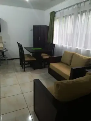 a living room with a couch and a table at Apartamento Lopez y Azofeifa in Portete
