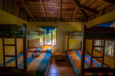 a bedroom with two bunk beds in a room at Casa de la Naturaleza in Cóbano
