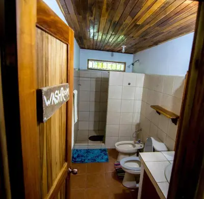 a bathroom with a toilet and a sink and a shower at Casa de la Naturaleza in Cóbano