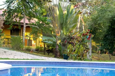 a house and a swimming pool in front of a house at Casa de la Naturaleza in Cóbano