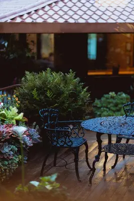 two chairs and a table in a garden at Trogon Lodge in San Gerardo de Dota