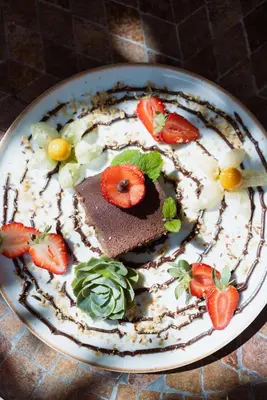 a dessert with chocolate and strawberries on a plate at Trogon Lodge in San Gerardo de Dota