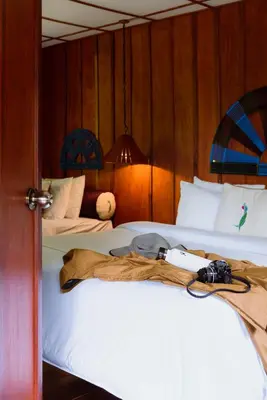 a bedroom with two beds with a camera on the bed at Trogon Lodge in San Gerardo de Dota