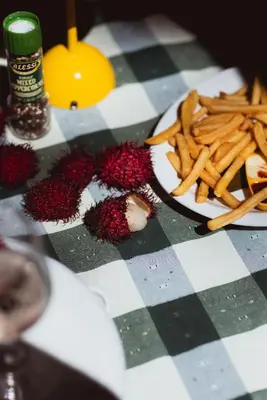 a table with a plate of food and french fries at Mawamba Lodge in Tortuguero