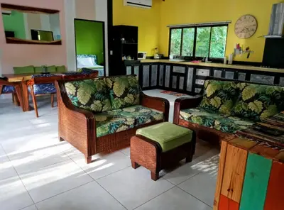 a living room with two chairs and a table at Casita Mar Y Posa in Potrero