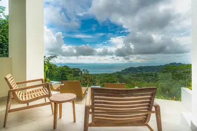 a balcony with chairs and a view of the ocean at Casa Frenchie with Private Guesthouse - by Pura Villas in Dominicalito