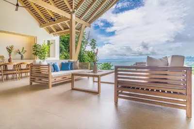a living room with two benches and a table at Casa Frenchie with Private Guesthouse - by Pura Villas in Dominicalito