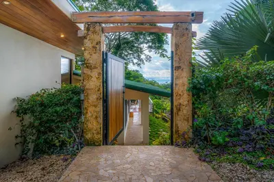 an entrance to a house with an open door at Casa Frenchie with Private Guesthouse - by Pura Villas in Dominicalito
