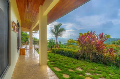 a house with a porch with a view of a garden at Casa Frenchie with Private Guesthouse - by Pura Villas in Dominicalito