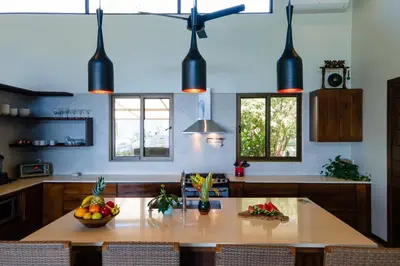 a kitchen with a table with fruit on it at Casa Ola Vista - by Pura Villas in Dominicalito
