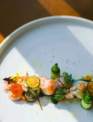 a plate of food with shrimp and vegetables on it at Casa Ola Vista - by Pura Villas in Dominicalito