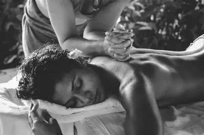 a man laying on a bed with a towel at Casa Ola Vista - by Pura Villas in Dominicalito