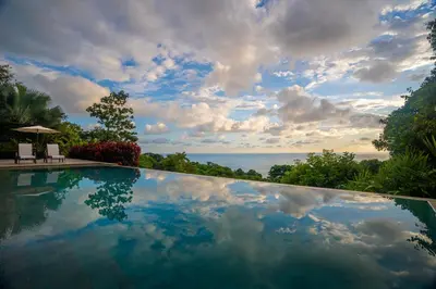 a swimming pool with a view of the ocean at Casa ReSol - by Pura Villas in Uvita