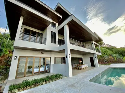 a villa with a swimming pool and a house at Casa ReSol - by Pura Villas in Uvita