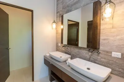 a bathroom with two sinks and a mirror at Casa ReSol - by Pura Villas in Uvita