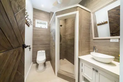 a bathroom with a toilet and a sink at Villa Harmonia in Potrero