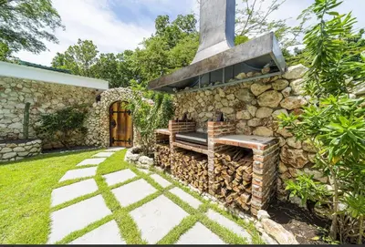 a stone wall with a bench next to a house at Villa Harmonia in Potrero