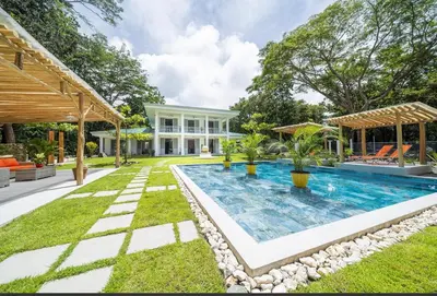 a swimming pool in the backyard of a house at Villa Harmonia in Potrero