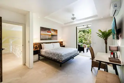 a bedroom with a bed and a desk at Villa Harmonia in Potrero