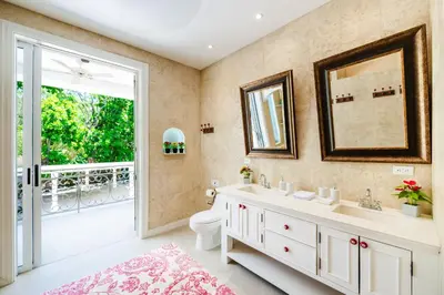 a bathroom with a sink and a toilet and a window at Villa Harmonia in Potrero