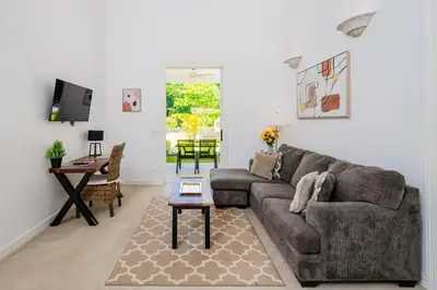 a living room with a couch and a table at Buendía Lux Mango Suite Stylish Retreat with Pool Near Beach in Potrero