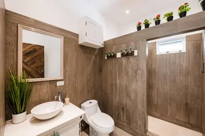 a bathroom with a white toilet and a sink at Buendía Lux Mango Suite Stylish Retreat with Pool Near Beach in Potrero