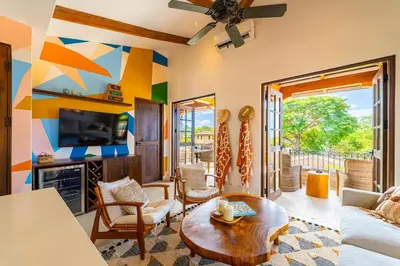 a living room with a couch and a tv at Plaza Mercado 22 At Las Catalinas in Playa Danta